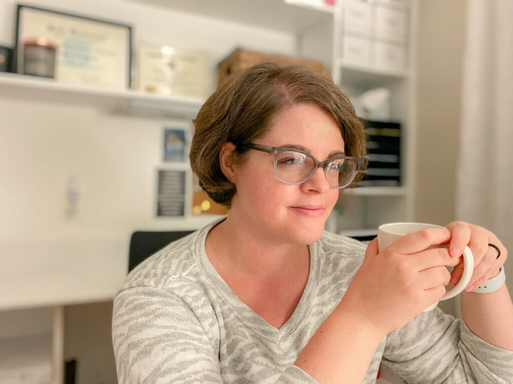 photo of Andrea Jean Homes holding a cup of coffee
